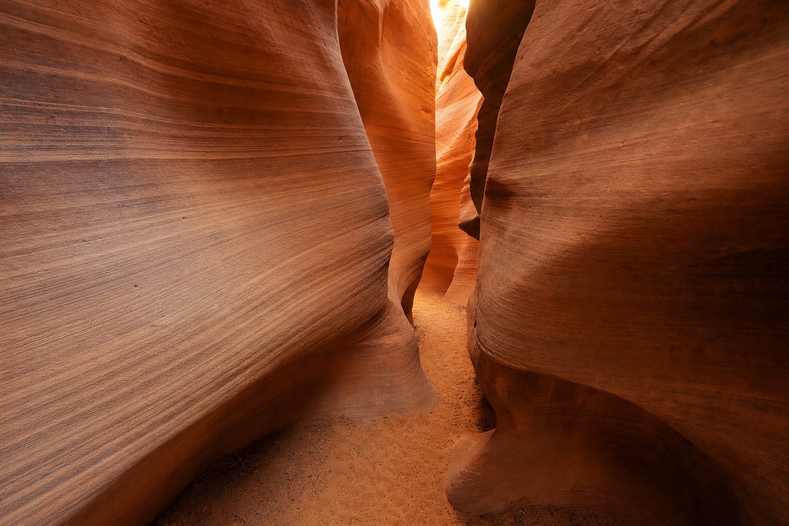 Quiet sandstone slot canyon corridor with layered orange walls and no visitors in sight