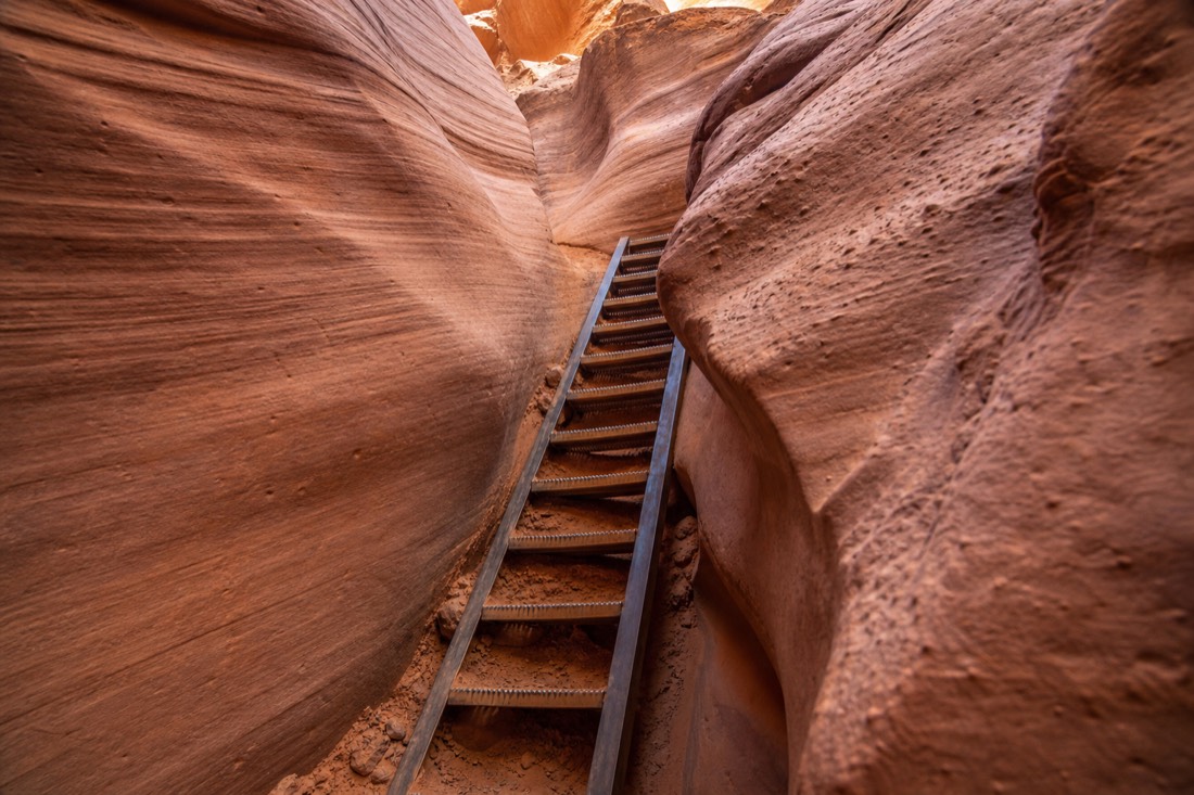 Steep ladder section between close sandstone walls inside Lower Antelope Canyon